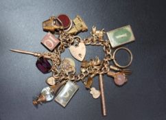 A HALLMARKED 9 CARAT GOLD CHARM BRACELET, adorned with approx 18 charms, approx weight 76.4g