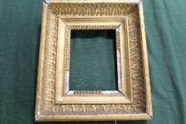 AN 18TH CENTURY GOLD FRAME, with egg and dart design to inner edge and leaf design to outer edge,