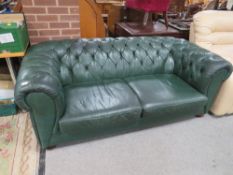 A GREEN LEATHER CHESTERFIELD SETTEE
