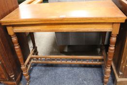 AN ANTIQUE FOLD-OVER CARD TABLE