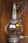 A PEWTER AND GLASS CLARET JUG