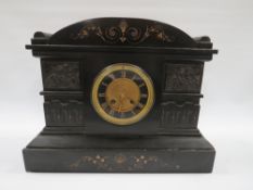 A LATE 19TH CENTURY BLACK SLATE MANTLE CLOCK, the case having an arched top with cherub panelled