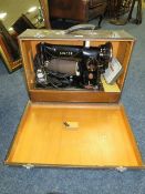 A CASED SINGER ELECTRIC SEWING MACHINE