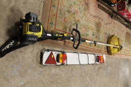 A TITAN PETROL STRIMMER AND A TOWING LIGHT BOARD