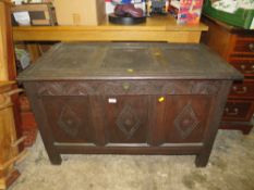 AN ANTIQUE CARVED OAK PANELLED COFFER