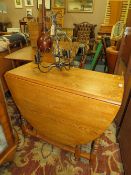AN OAK DROPLEAF TABLE PLUS A LIGHT FITTING