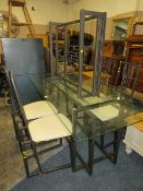 A GLASS TOPPED DINING TABLE WITH FOUR CHAIRS AND A GLASS TOPPED CONSOLE TABLE