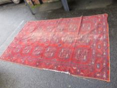 A VINTAGE RED WOOLLEN RUG 254 X 154 cm