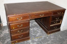 A LATE 19TH / EARLY 20TH CENTURY OAK TWIN PEDESTAL DESK, having an inset leather top above an