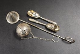 A SILVER DIFFUSER STAMPED STERLING, TWO UNUSUAL PIERCED SCOOPS STAMPED STERLING, AND A CANDLE