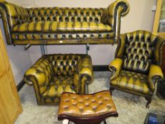 A VINTAGE LEATHER CHESTERFIELD SETTEE , CHAIR AND WING CHAIR WITH STOOL (4)