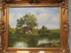 A GILT FRAMED OIL ON CANVAS OF A RIVERSIDE WATERMILL SIGNED LOWER RIGHT 