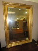 A MODERN GILT RECTANGULAR WALL MIRROR 109 X 79 cm