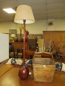 A LARGE WOODEN CARRY BASKET - H 58 cm, W 40 cm TOGETHER WITH A STANDARD LAMP (2)