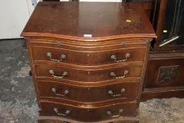 A REPRODUCTION SERPENTINE CHEST OF FOUR DRAWERS WITH BRUSHING SLIDE - A/F