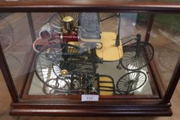 A MODEL OF AN ANTIQUE STEAM POWERED MOTOR CAR IN A GLASS AND MAHOGANY DISPLAY CASE
