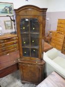 A REPRODUCTION WALNUT CORNER CABINET