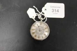 A CONTINENTAL STYLE OPEN FACED MANUAL WIND FOB WATCH WITH ORNATE SILVER DIAL AND GOLD COLOURED ROMAN