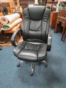 A MODERN BLACK OFFICE SWIVEL CHAIR
