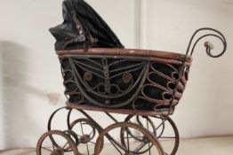 A SMALL VINTAGE BENT IRON AND WICKER DOLLS PRAM