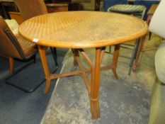 A CIRCULAR WICKER TABLE