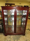 A MODERN TWO DOOR BOOKCASE