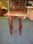 A SMALL OAK CARVED TABLE
