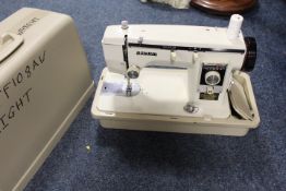 A VINTAGE CASED VOVUM SEWING MACHINE