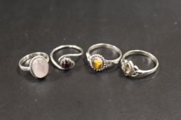 A COLLECTION OF 4 SILVER GEMSTONE DRESS RINGS TO INCLUDE OPAL, ONYX ETC