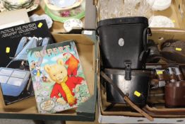 TWO TRAYS OF COLLECTABLES TO INCLUDE CASED BINOCULARS . RUPERT ANNUAL AND A SCHLUMEN COLLECTION