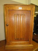 AN OAK LINENFOLD BEDSIDE CABINET