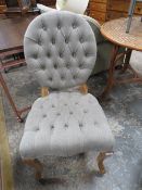 A MODERN UPHOLSTERED BEDROOM CHAIR