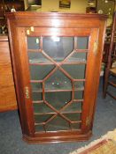 A 19TH CENTURY OAK GLAZED HANGING CORNER CUPBOARD