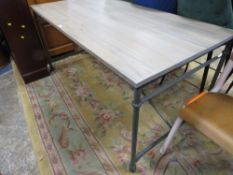 A MODERN INDUSTRIAL STYLE LIMED TABLE WITH CASTORS