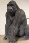 A LARGE RESIN GORILLA Height 52 cm Base 40 x 24 cm