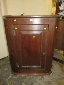 A GEORGIAN OAK HANGING CORNER CUPBOARD