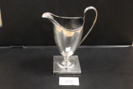 AN ANTIQUE SILVER CREAM JUG