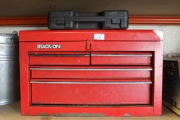 A RED FOUR DRAWER TOOL BOX AND AN AIR CHISEL