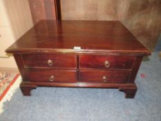 A MODERN COFFEE TABLE WITH DRAWERS