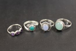 A COLLECTION OF 4 SILVER GEMSTONE DRESS RINGS TO INCLUDE OPAL, TIGERS EYE, CITRINE ETC