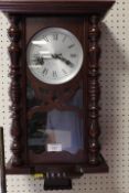 A MODERN 31 DAY MAHOGANY WALL CLOCK