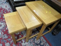 A MODERN NEST OF OAK TABLES