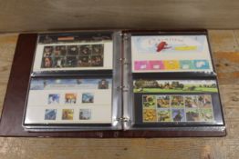 AN ALBUM CONTAINING VARIOUS STAMP COLLECTORS SETS