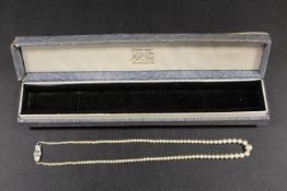 A CULTURED PEARL NECKLACE WITH 9CT WHITE GOLD AND DIAMOND FASTENER