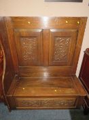 AN UNUSUAL CARVED OAK MONKS BENCH - W 120 cm