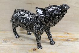 A LARGE METAL FIGURE OF A PIGLET