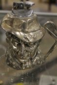 A NOVELTY CHROME EFFECT CIGARETTE LIGHTER IN A FORM OF A GOLFER CHARACTER JUG