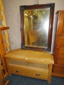 A MODERN OAK TV / MEDIA CABINET TOGETHER WITH A RECTANGULAR MIRROR (2)