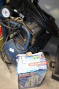 AN AIR COMPRESSOR AND A BOXED SPRAY GUN