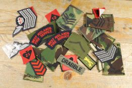 A BAG OF MILITARY CLOTH BADGES